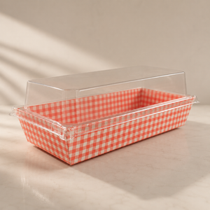 Rectangular baking dish with red and white checkered interior and clear lid on a beige background