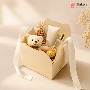 Gift basket with teddy bear, perfume, and cookies on a beige background with 'Bakey' branding.