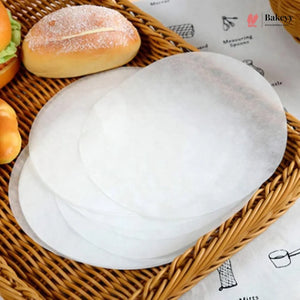 White bread loaf and buns in a wicker basket with 'Bakey' branding.