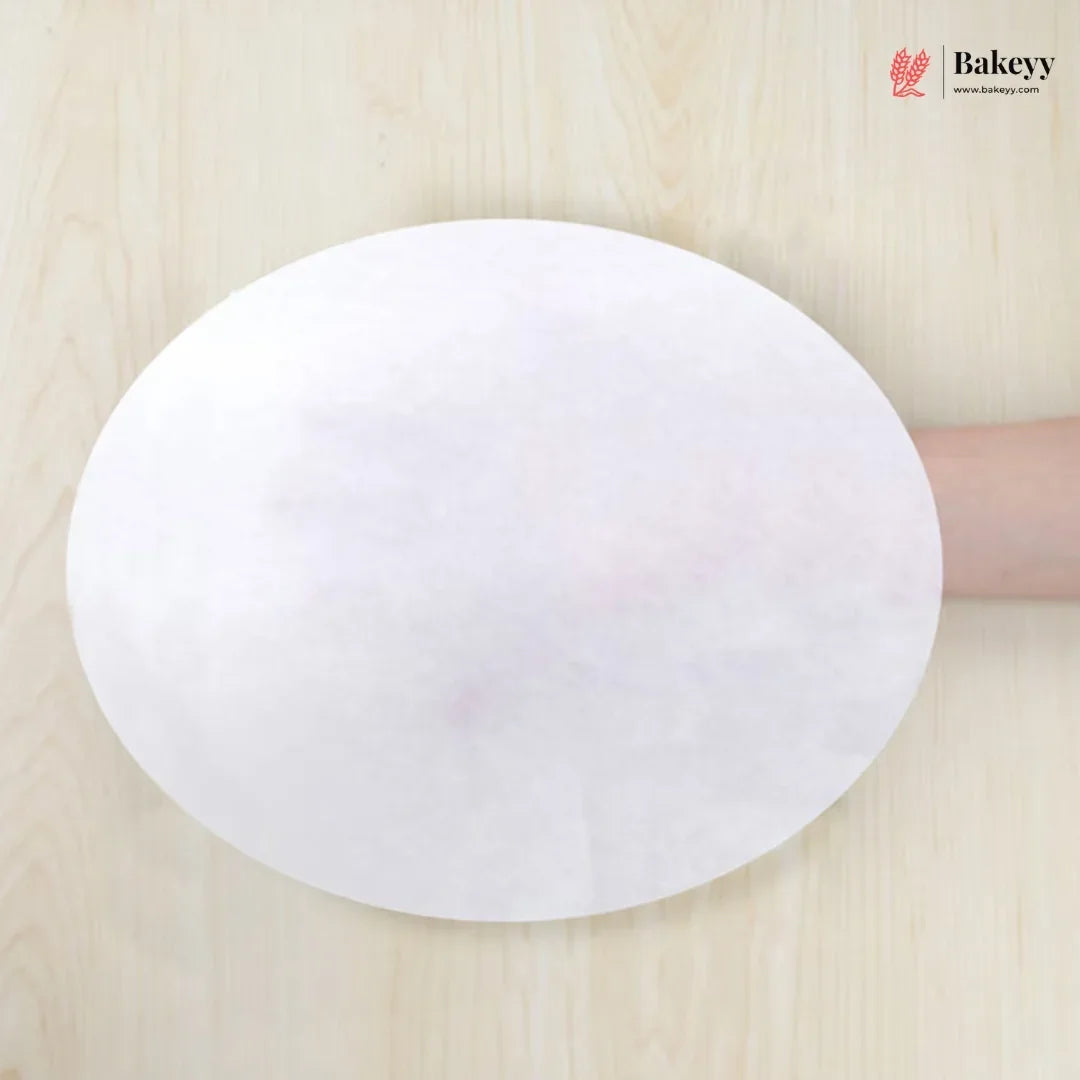 White round paper towel held by a hand on a wooden surface with 'Bakeey' branding.