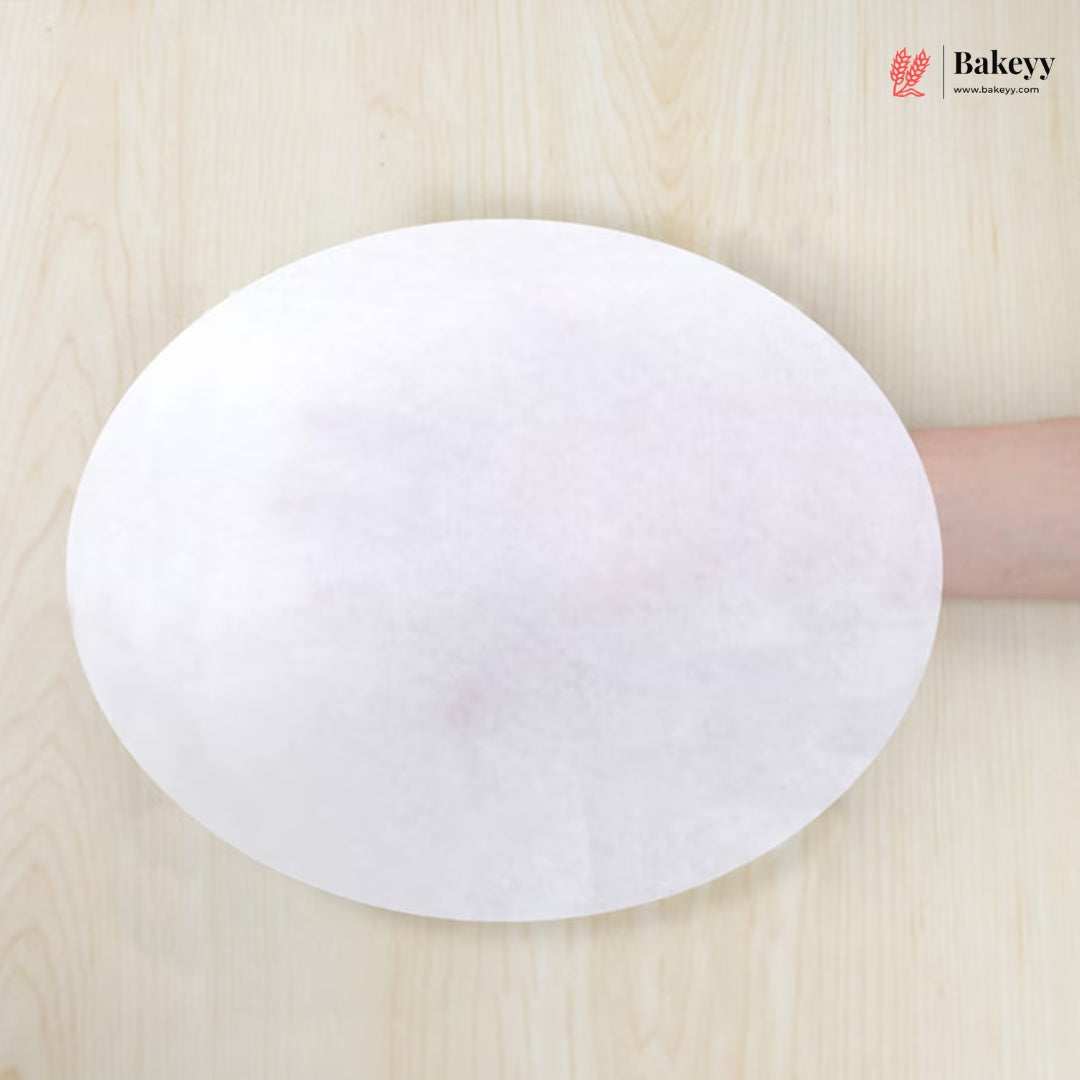 White round paper towel held by a hand on a wooden surface with 'Bakeey' branding.
