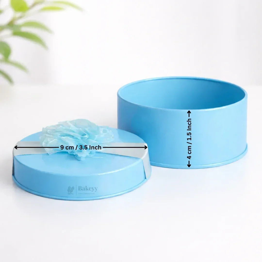 Blue round decorative metal tin box with ribbon, 9 cm diameter, 4 cm height, gift packaging.