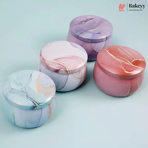 Four round marble-patterned lidded containers in pastel shades of purple, pink, blue, and coral, arranged on a light blue background. A Bakeey logo appears in the top right corner.