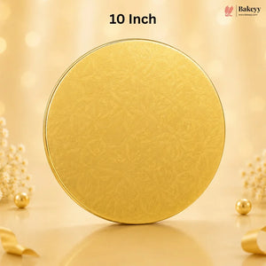 A round gold-colored tin with a subtle embossed floral pattern, standing upright on a reflective surface. The background is a warm, soft beige with bokeh lights and decorative pearl-like flowers.