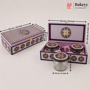 Decorative purple and gold ceramic tea set with a matching storage box, shown closed and open with dimension labels. The set includes a glass jar with a purple lid, two small ceramic jars with purple lids, and a larger open box containing the jars, all on a light gray background with Bakeyy branding.