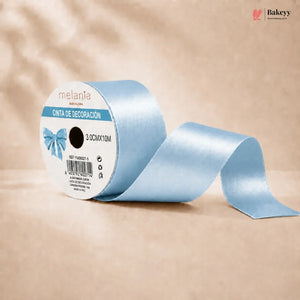 Roll of light blue ribbon with a decorative label on a beige background