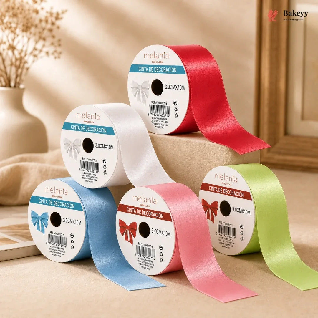 Set of colorful ribbons on spools with 'melania' branding against a neutral background.