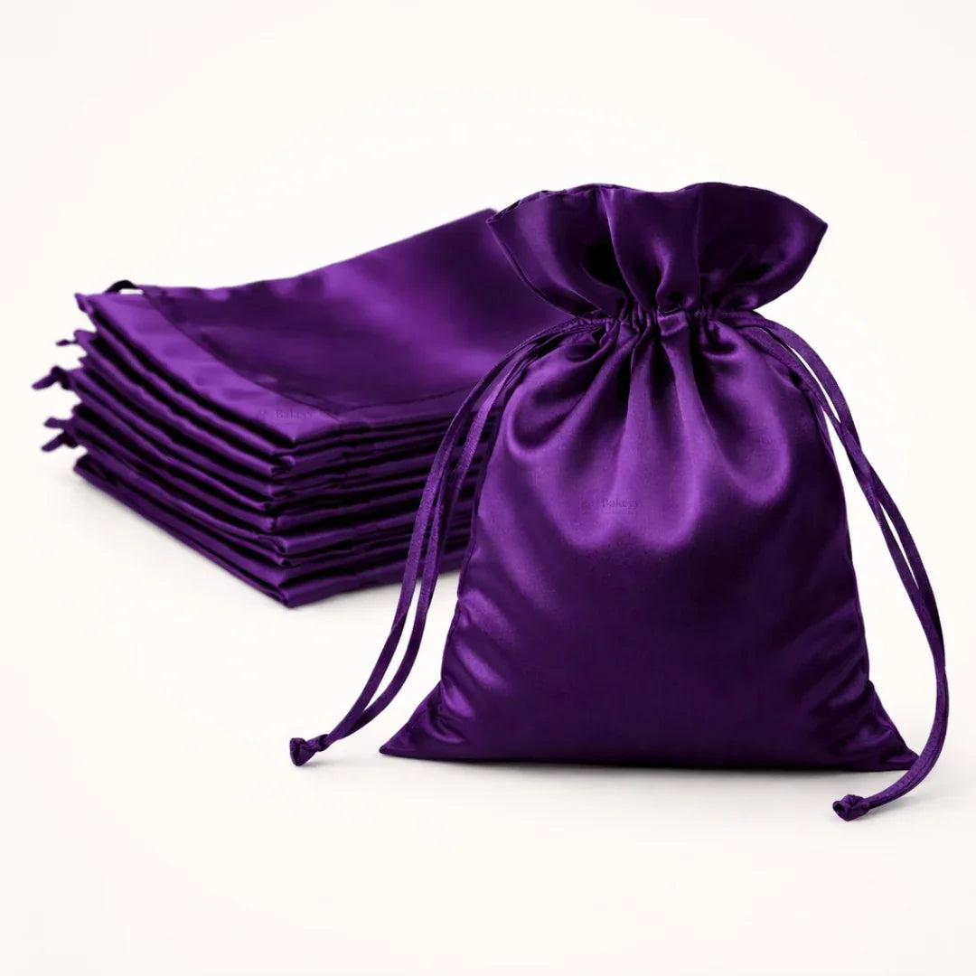 Purple satin drawstring bags on a white background