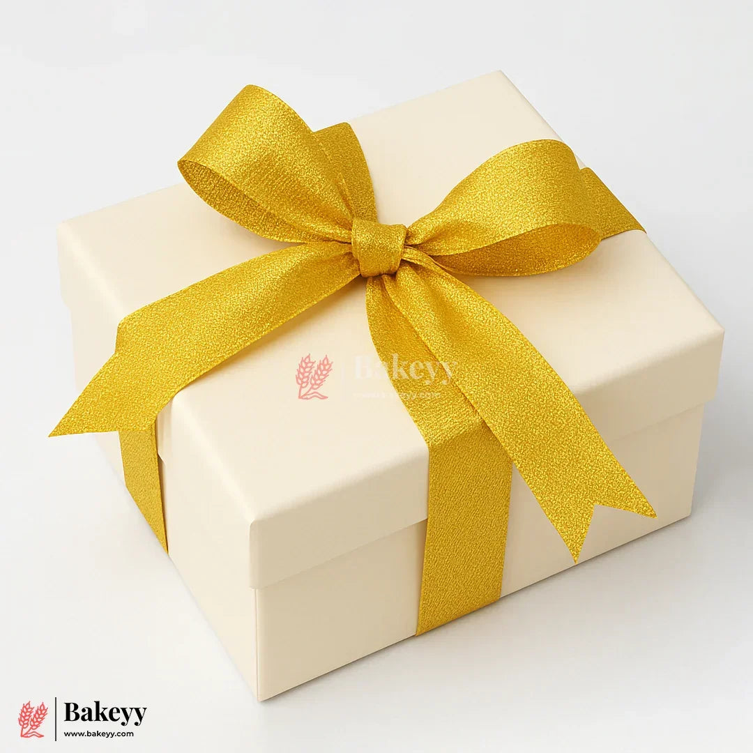 Beige gift box with a yellow ribbon on a white background, featuring the Bakeyy brand.