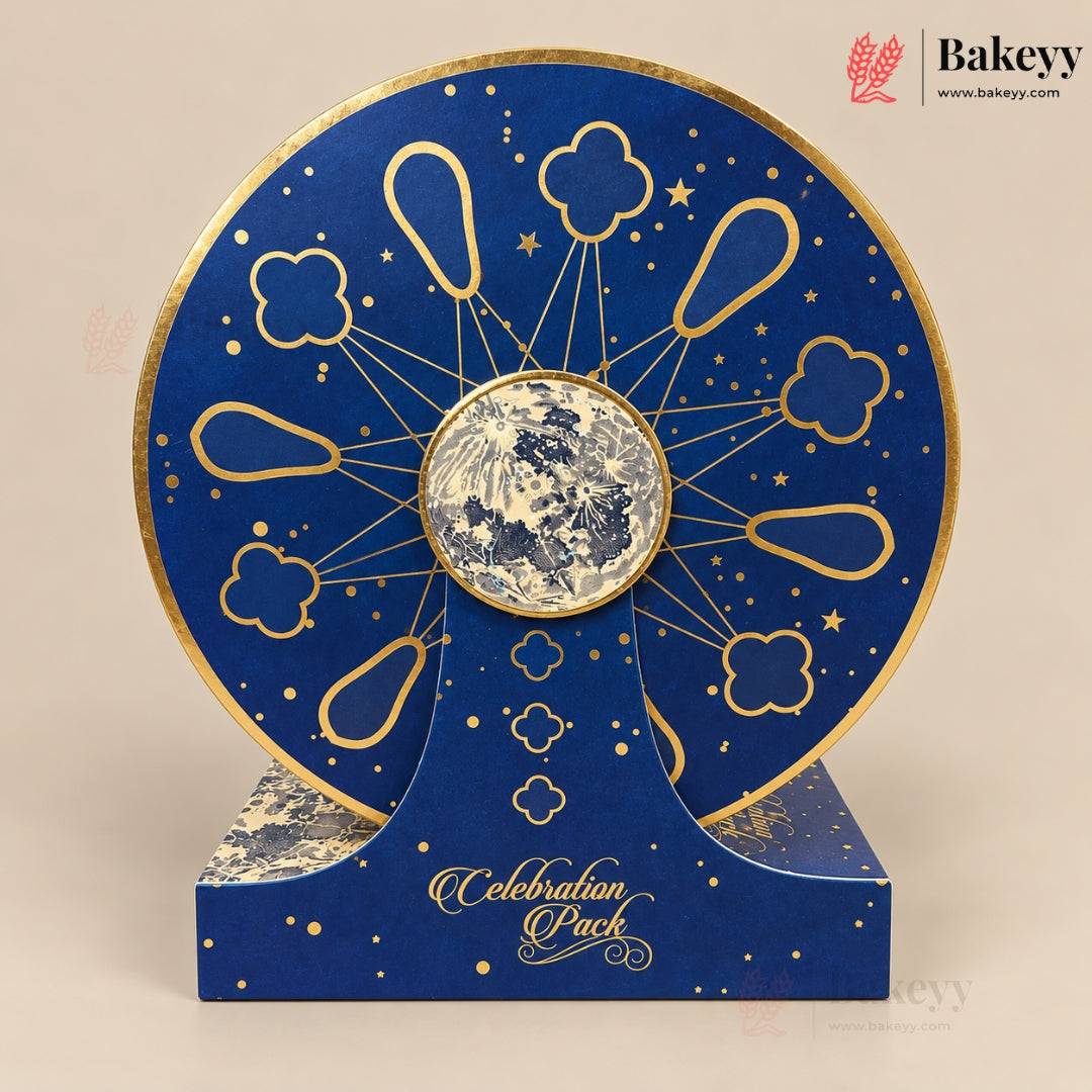 A round blue and gold moon phase display stand with a central moon window, shown on a matching branded base against a beige background. The Bakeyy logo appears in the top right corner.
