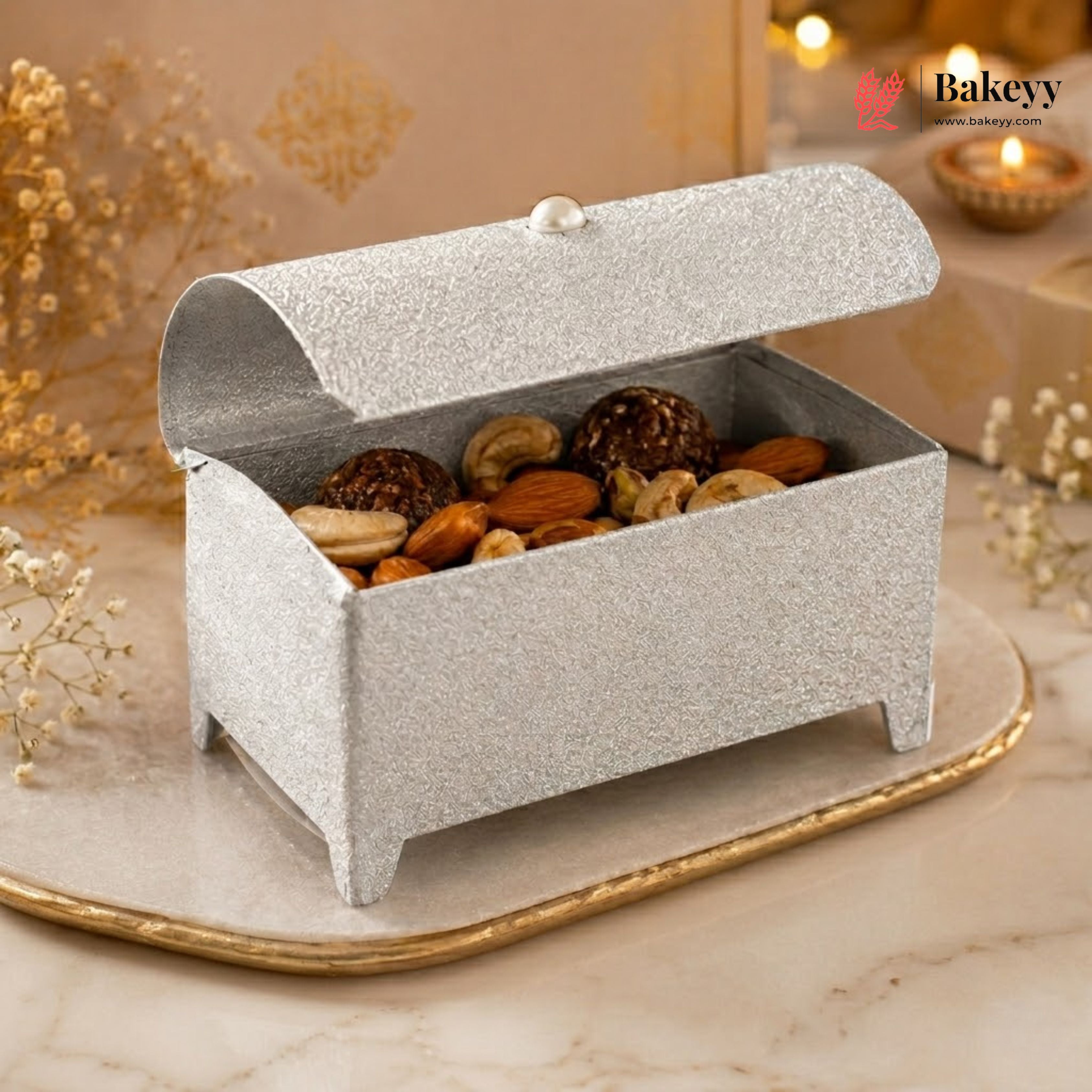 Decorative box filled with almonds on a marble surface with 'Bakey' branding.