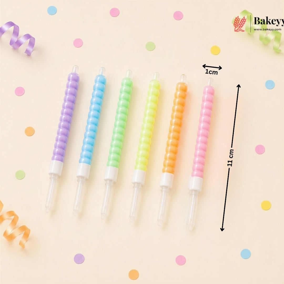 Set of colorful spiral candles with measurements on a light beige background