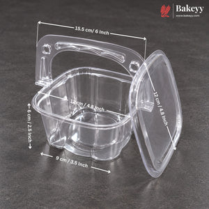 Clear plastic square baking dish with handle and matching lid, shown on a dark gray surface with overlaid dimension arrows and labels. Bakeey logo appears in the top right corner.