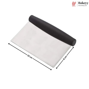 A metal pastry scraper with a black handle, shown on a white background with black dimension arrows indicating 15 cm length and 8 cm width. A Bakeyy logo is visible in the top right corner.