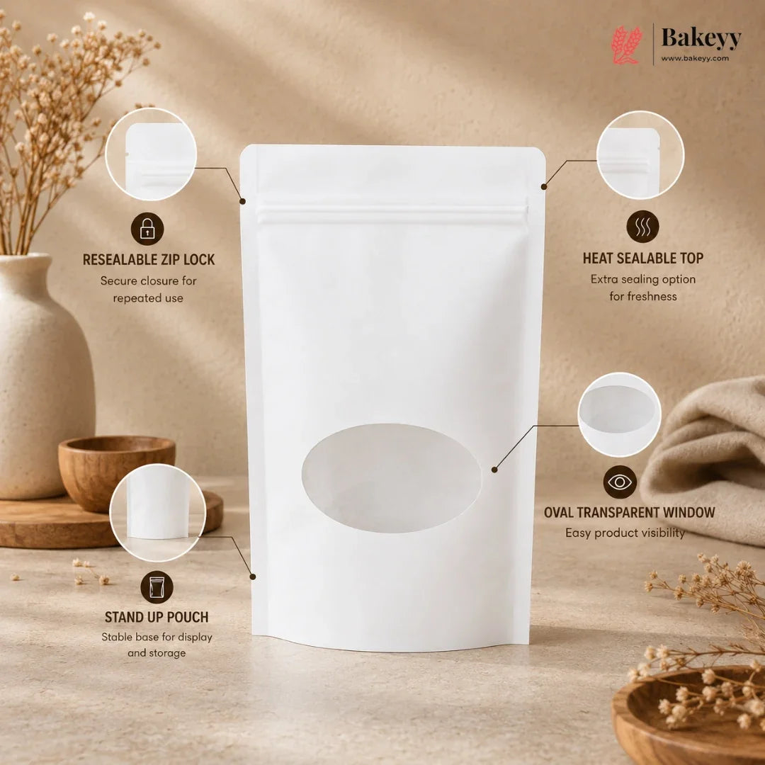 A white stand-up pouch with a resealable zipper, heat sealable top, and oval transparent window, shown on a beige tabletop with decorative dried flowers and props. Callout circles with text explain the pouch features.