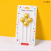 Gold heart-shaped candles in packaging with 'Happy Birthday' text on a yellow background
