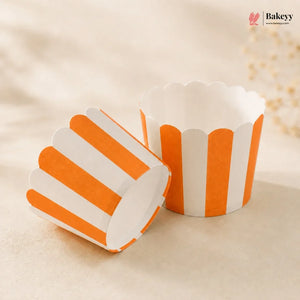 Orange and white striped cupcake liners on a beige background