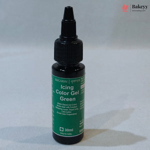 A 30ml bottle of Sugarin Icing Color Gel Green, featuring a dark green label and a black plastic dropper cap, set against a light gray fabric background.