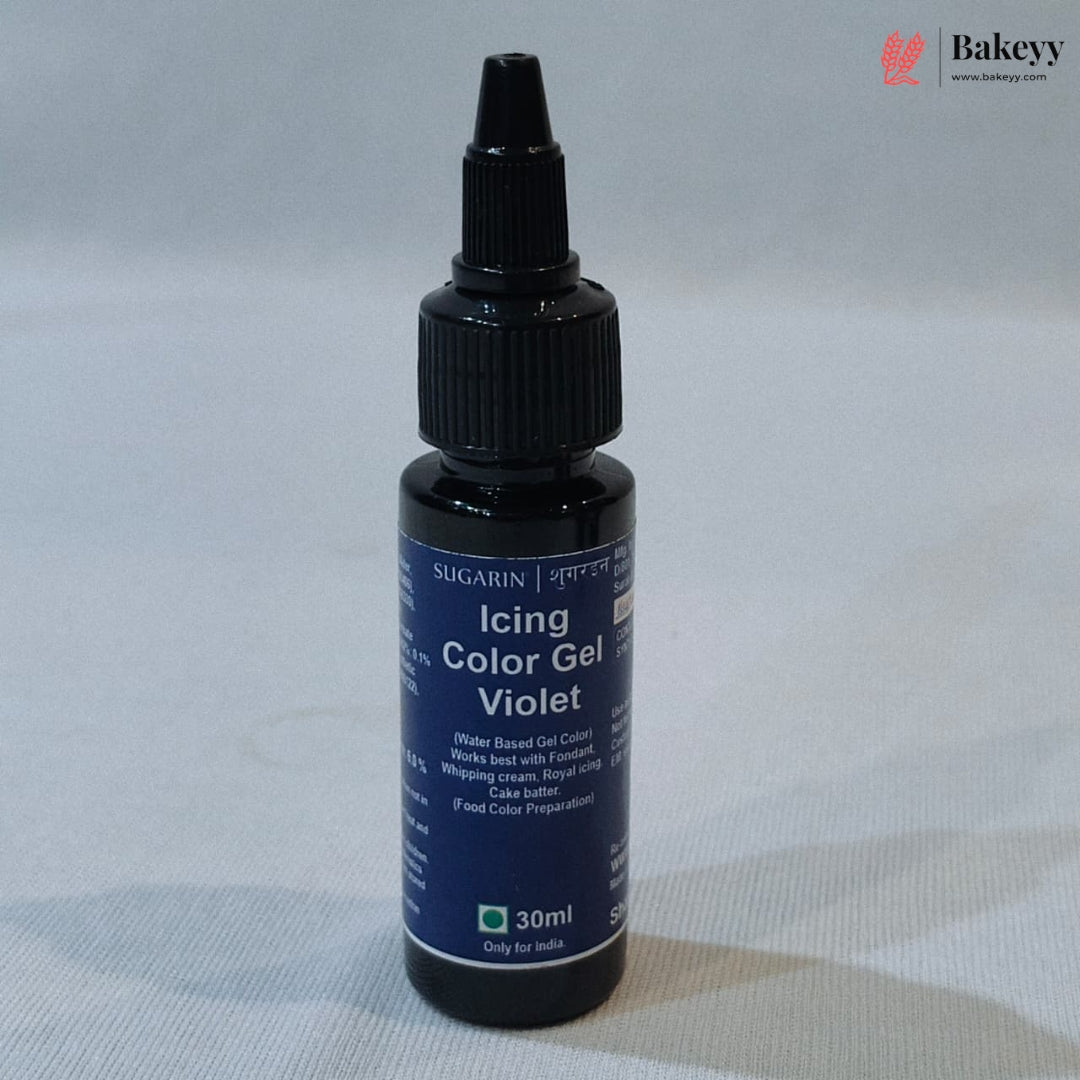 A 30ml bottle of Sugarin Baking Color Gel in the violet shade, featuring a dark blue label and a black plastic dropper cap, set against a light gray fabric background.