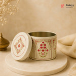 Decorative tin with floral patterns on a beige background, featuring the Bakeyy brand.