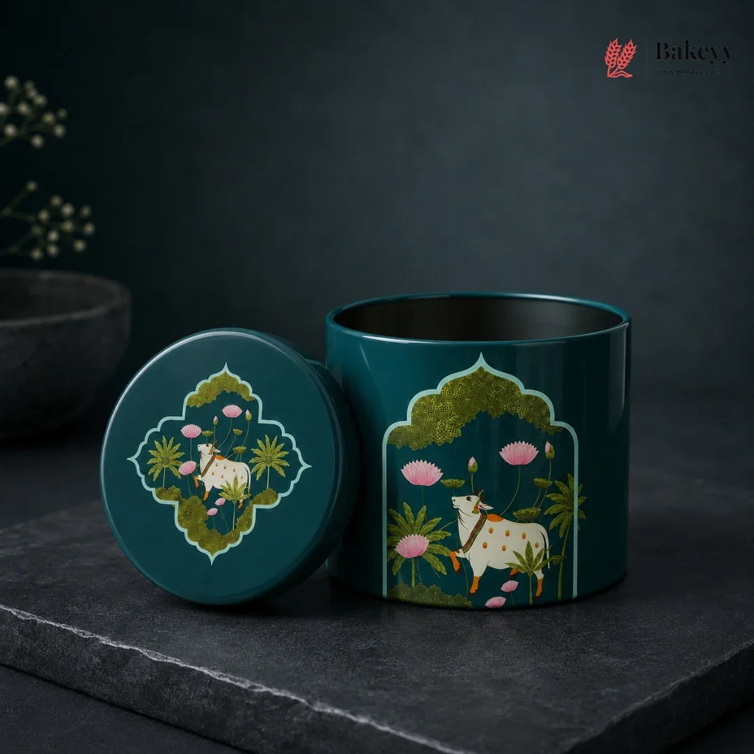Decorative teal container with cow and floral design on a dark background