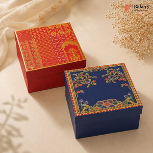 Two decorative gift boxes on a cream fabric background, one red with gold patterns and one navy blue with multicolor floral and peacock motifs. A Bakeey logo watermark is visible in the top right.