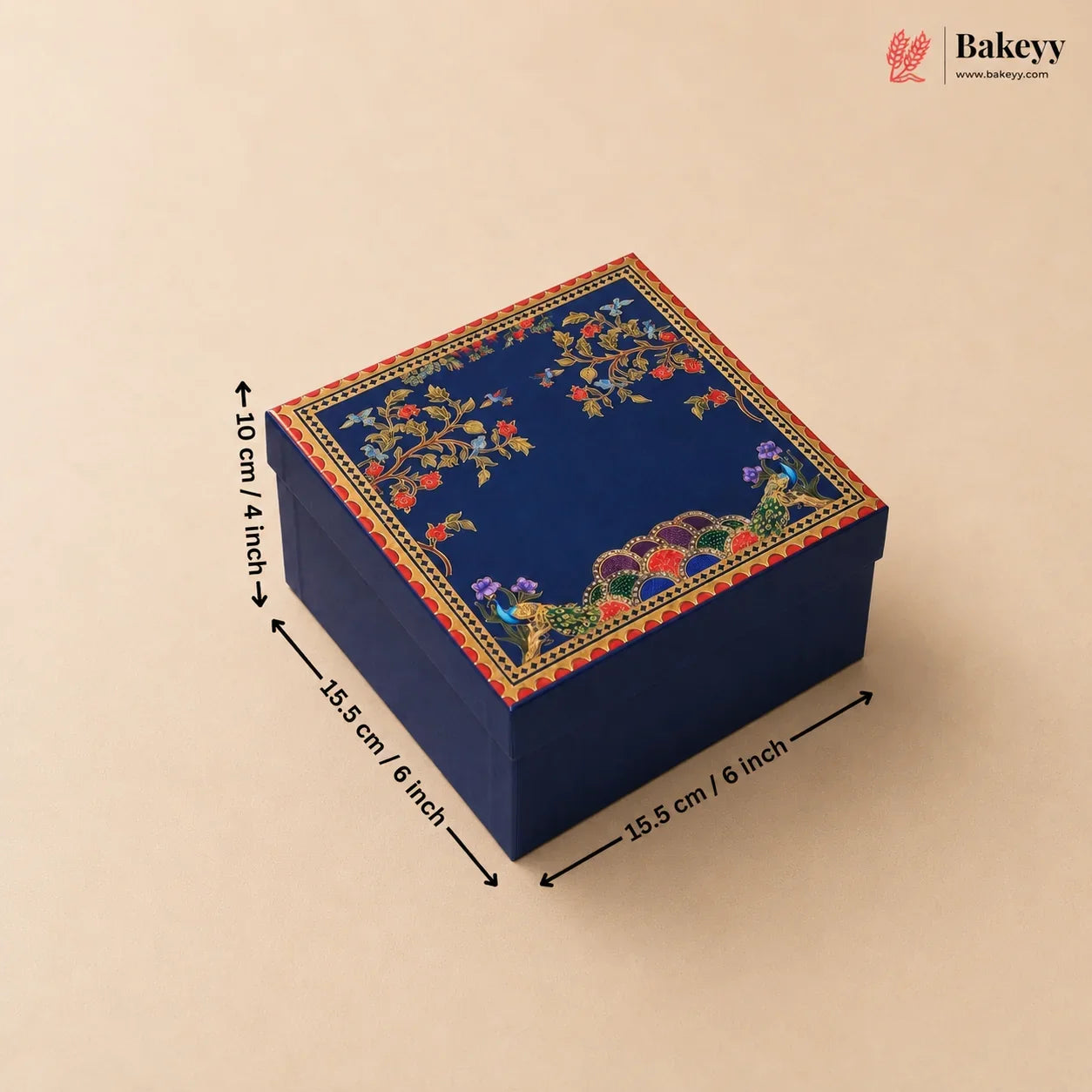 A square navy blue decorative gift box with colorful floral and bird motifs on the lid, shown on a beige background with black dimension arrows and text indicating 15.5 cm by 10 cm by 15.