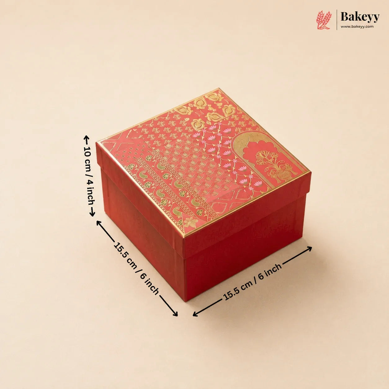 A red square gift box with a gold patterned lid, shown on a light beige background with black dimension arrows and text indicating 15.5 cm / 6 inch sides and 10 cm / 4 inch height.