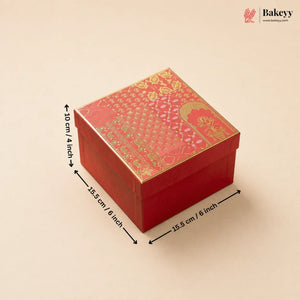 A red square gift box with a gold patterned lid, shown on a light beige background with black dimension arrows and text indicating 15.5 cm / 6 inch sides and 10 cm / 4 inch height.