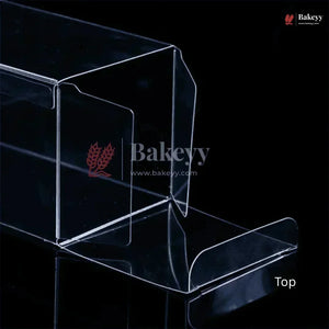Clear acrylic display stand with Bakeyy branding on a black background