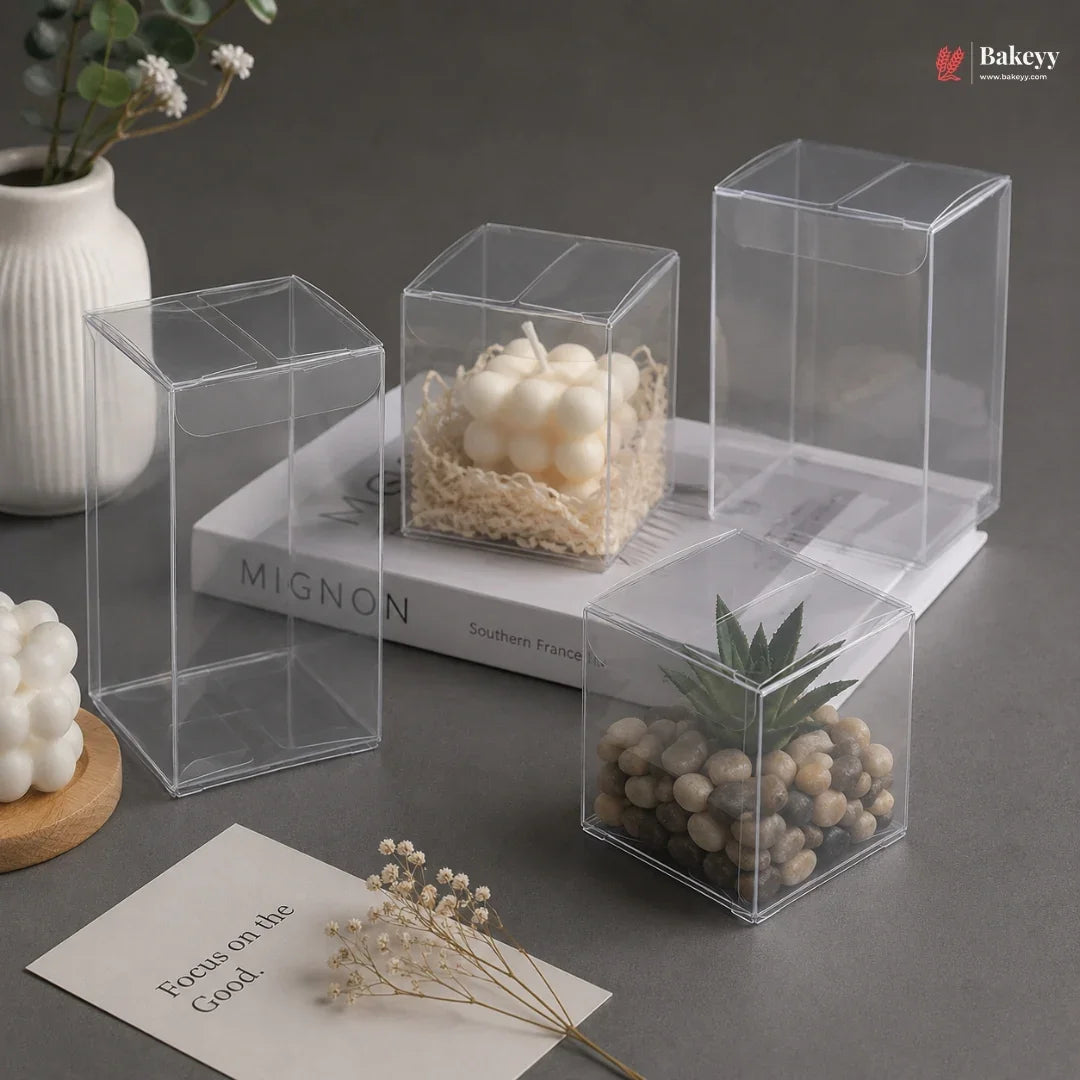 Clear plastic boxes containing decorative items on a dark surface with 'Bakey' branding.