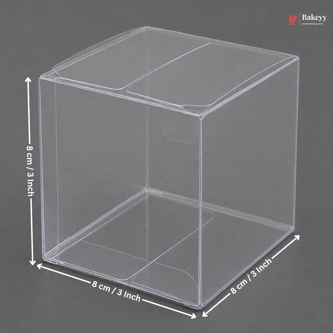 Clear plastic cube with dimensions labeled on a gray background