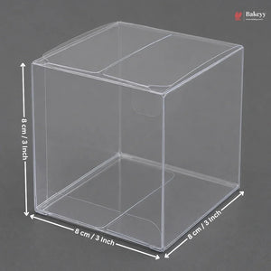 Clear plastic cube with dimensions labeled on a gray background