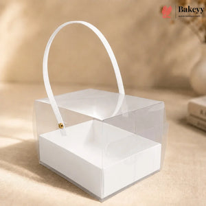 Clear acrylic box with white handle on a beige background, featuring the Bakey brand.
