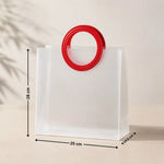 White paper bag with a red circular handle and measurements on a beige background
