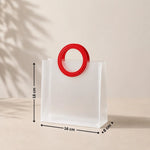 White bag with a red handle and measurements on a beige background