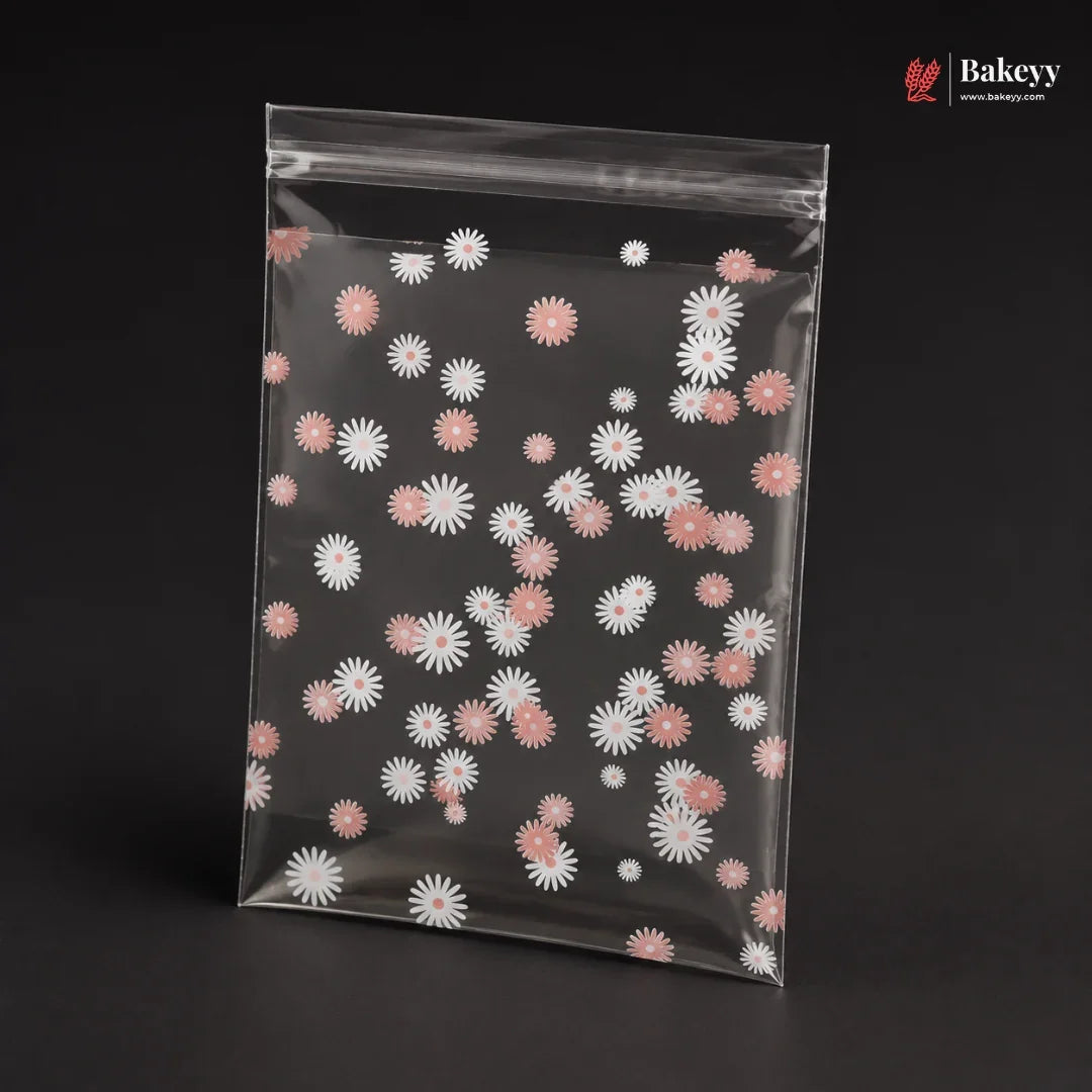 Clear plastic bag with pink and white floral pattern on a black background, featuring the brand 'Bakeyy'.