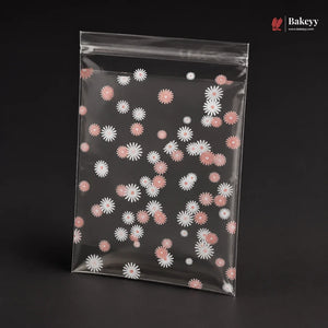 Clear plastic bag with pink and white floral pattern on a black background, featuring the brand 'Bakeyy'.