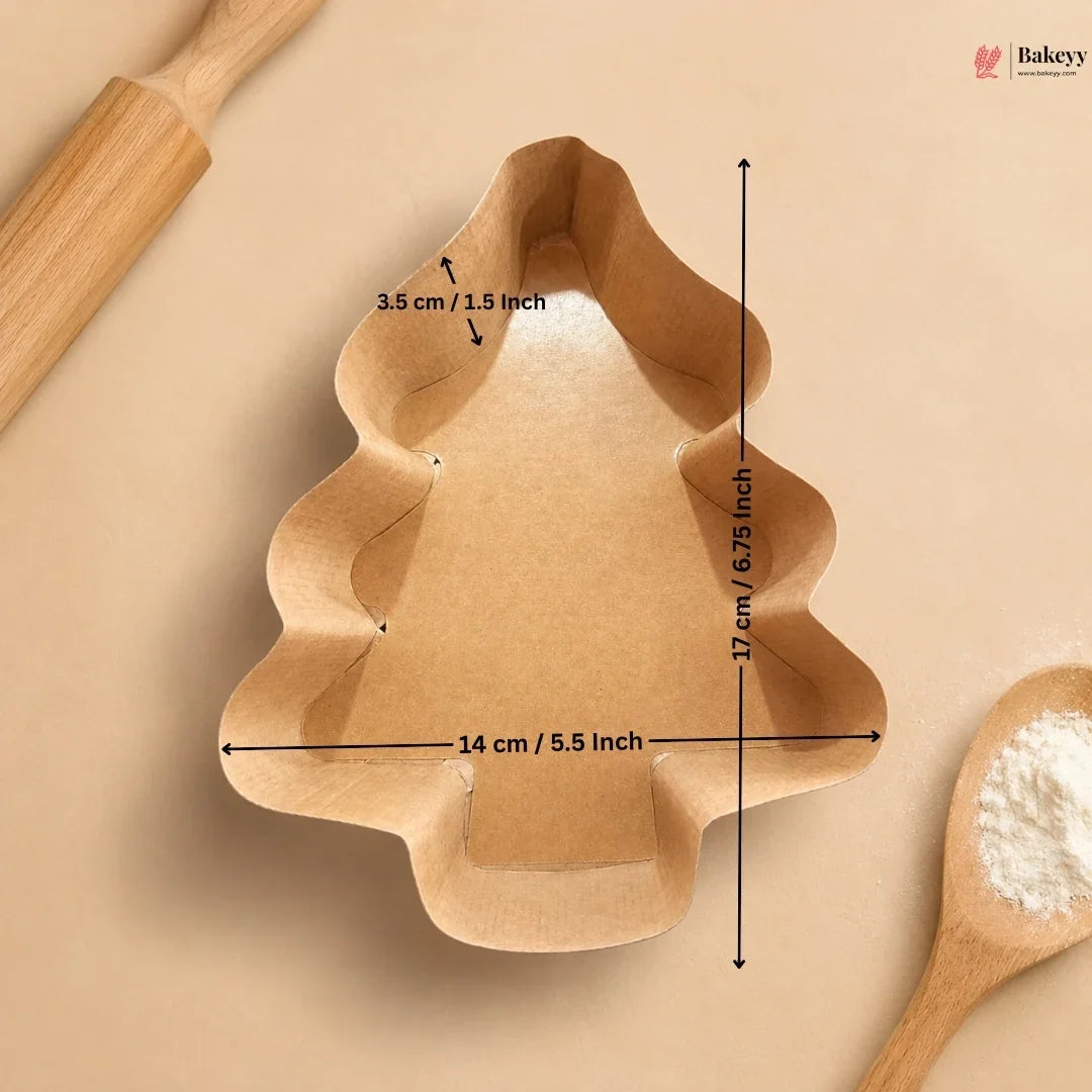 Tree-shaped cookie cutter with measurements on a beige background
