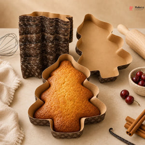 Tree-shaped cake in a mold with baking tools and ingredients on a table
