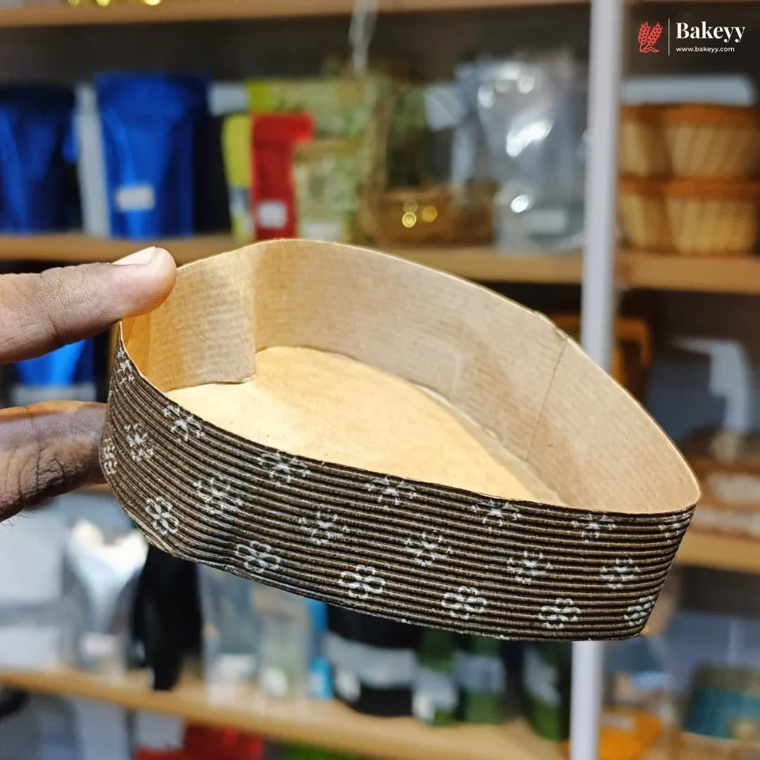 Wooden pet bed with patterned fabric lining held by a hand in a store setting.