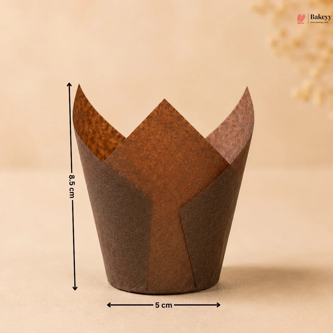 Brown tulip-shaped paper cupcake wrapper with measurements on a beige background