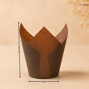 Brown tulip-shaped paper cupcake wrapper with measurements on a beige background