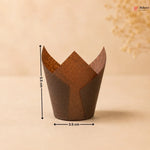 Brown paper cupcake wrapper with measurements on a beige background