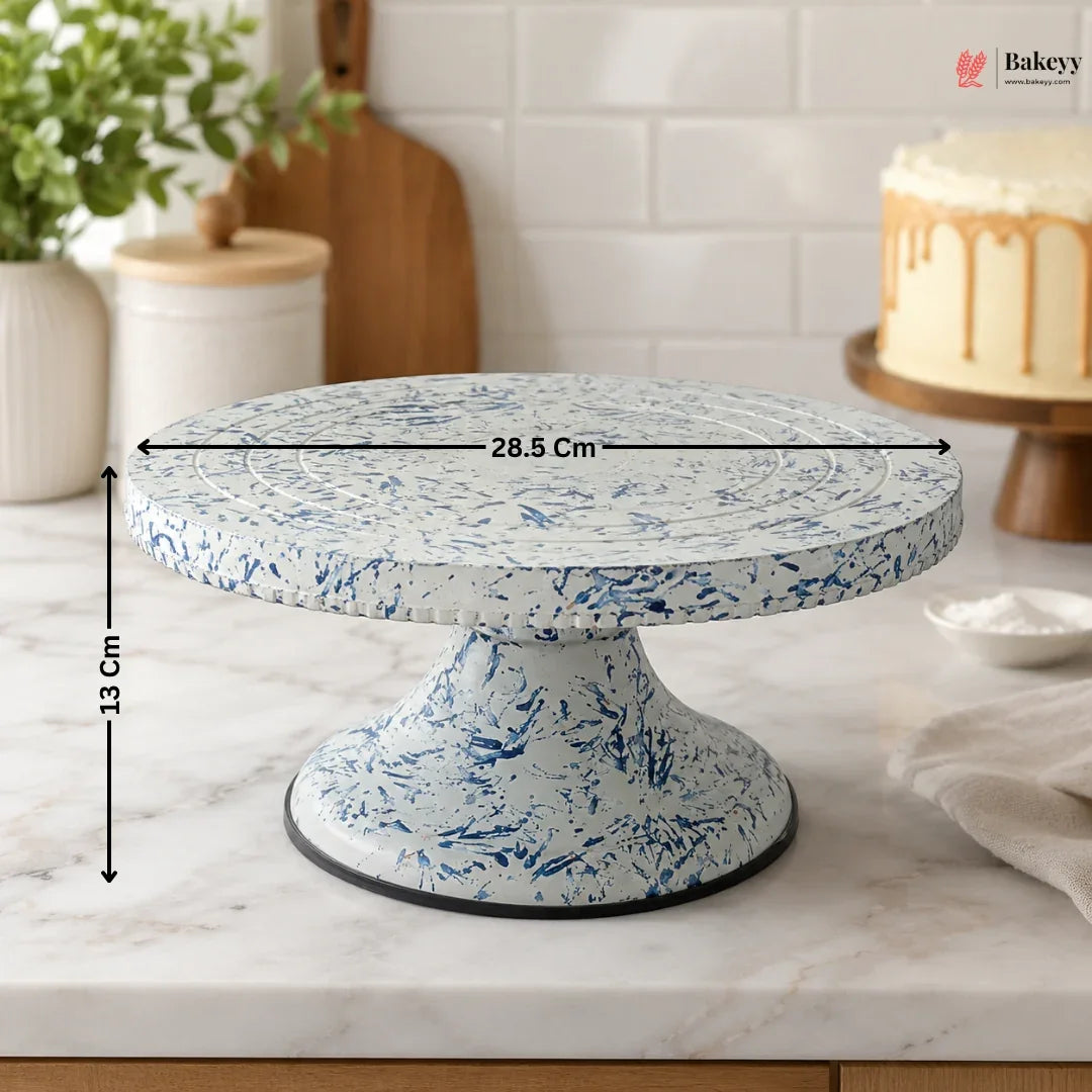 Speckled blue and white cake stand with measurements on a kitchen counter.
