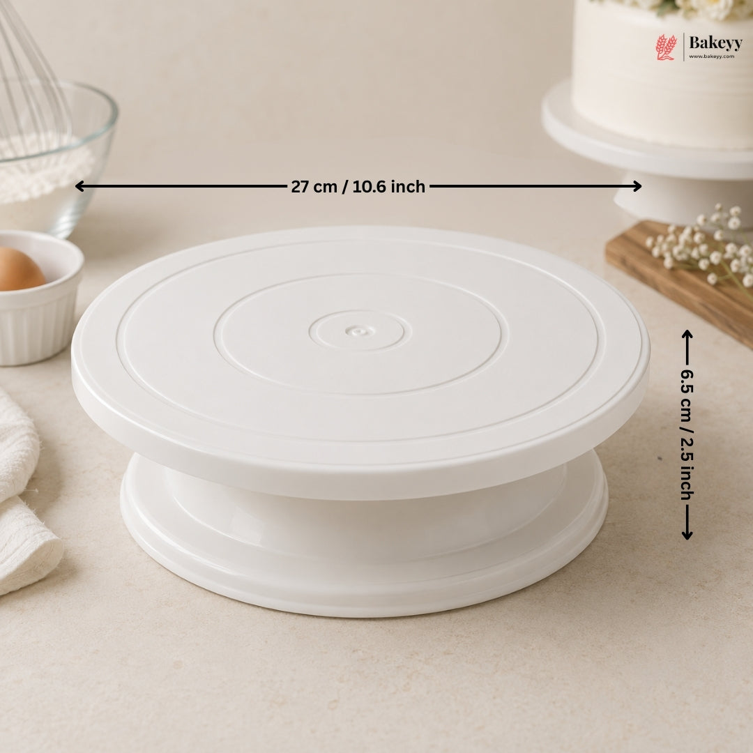 White cake turntable with measurements on a kitchen counter