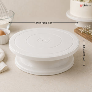 White cake turntable with measurements on a kitchen counter