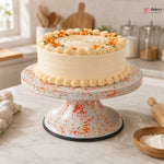Decorative cake on a marble stand with a kitchen background