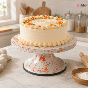 Decorative cake on a marble stand with a kitchen background