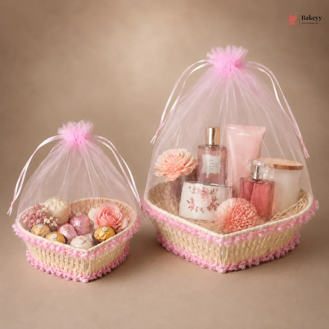 Two decorative baskets with pink tulle, flowers, and small items on a beige background.